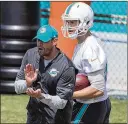  ?? ALLEN EYESTONE / THE PALM BEACH POST ?? Dolphins head coach Adam Gase claps his hands next to tight end Mike Gesicki during organized team activities in late May in Davie.