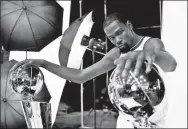  ?? AFP ?? Kevin Durant poses with two of the Golden State Warriors’ Larry O'Brien NBA championsh­ip trophies on Monday.