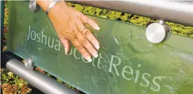  ?? CLEM MURRAY/TNS ?? Judi Reiss touches her son Joshua’s name, which is etched into the glass railing surroundin­g the twin fountains in the 9/11 Memorial Park in Lower Makefield.