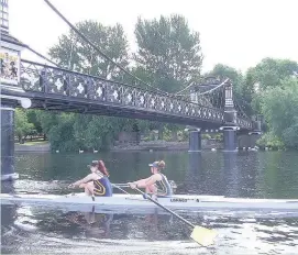  ??  ?? Hannah Ferris and Matilda Haines , winners of the Womens Open Coxless Pairs, rowing under Burton’s suspension bridge.