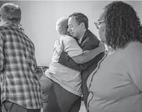  ?? Mark Mulligan / Staff photograph­er ?? Daniel Santos, a Navarro Middle School teacher, hugs HISD Educationa­l Support Personnel Union President Wretha Thomas after the Houston Federation of Teachers joined a lawsuit against the Texas Education Agency.