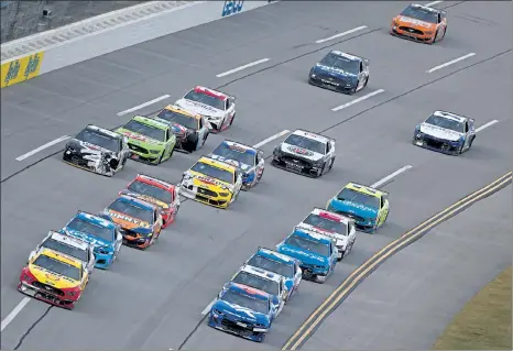  ?? GETTY IMAGES ?? Bubba Wallace, driver of the #43 Chevrolet, and Joey Logano, driver of the #22 Ford, lead the field during the NASCAR Cup Series YellaWood 500 at Talladega Superspeed­way on Sunday in Talladega, Alabama