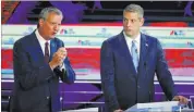  ??  ?? New York City Mayor Bill de Blasio speaks during the Democratic primary debate as Rep. Tim Ryan listens.