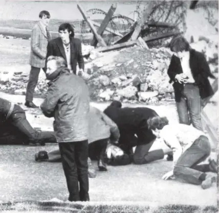  ??  ?? A man receives attention during the Bloody Sunday shootings in Londonderr­y, Northern Ireland, in 1972