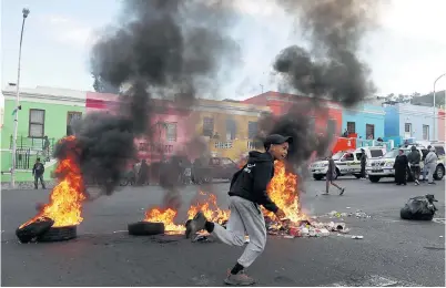  ??  ?? Tyres are burnt this week during continuing protests against further developmen­t in the Bo-Kaap.