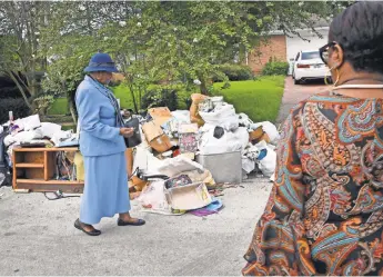  ?? PHOTOS BY LARRY MCCORMACK, THE TENNESSEAN, VIA USA TODAY NETWORK ?? “We’ve been pulling wet stuff out of the house all night,” says Helen Benjamin, who with her family was forced to flee her home of more than 50 years when the waters rose in Houston.