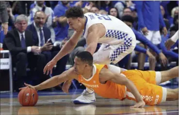  ?? JAMES CRISP — THE ASSOCIATED PRESS ?? Kentucky’s Reid Travis, top, and Tennessee’s Grant Williams chase down a loose ball during the first half Feb. 16 in Lexington, Ky.