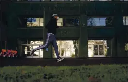  ?? RICH PEDRONCELL­I — THE ASSOCIATED PRESS FILE ?? A runner passes the office of the California Employment Developmen­t Department.