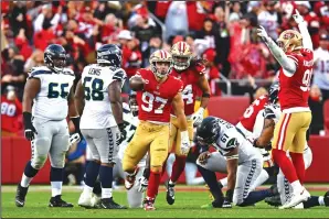  ?? JOSE CARLOS FAJARDO/BAY AREA NEWS GROUP ?? The 49ers’ Nick Bosa (97) celebrates after recovering a Seahawks fumble in the third quarter of their NFC wildcard playoff game in Santa Clara, on Saturday.