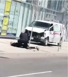  ??  ?? A police officer arrests a suspect in Monday’s deadly van attack in Toronto. Police sources identified the officer as Const. Ken Lam.