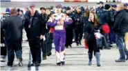  ?? THE ASSOCIATED PRESS ?? Denny Hamlin, center, leaves the track after Sunday’s race at Martinsvil­le Speedway in Martinsvil­le, Va. He wrecked with Chase Elliott late in the race.