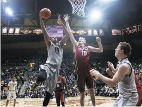  ?? Marcio Jose Sanchez / Associated Press ?? Cal forward Christian Behrens drives against Stanford’s Michael Humphrey last month in Berkeley. Behrens has bounced back from two ACL surgeries.