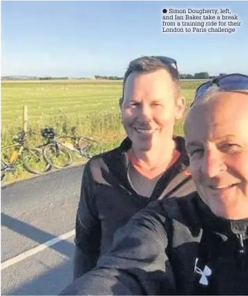  ??  ?? Simon Dougherty, left, and Ian Baker take a break from a training ride for their London to Paris challenge
