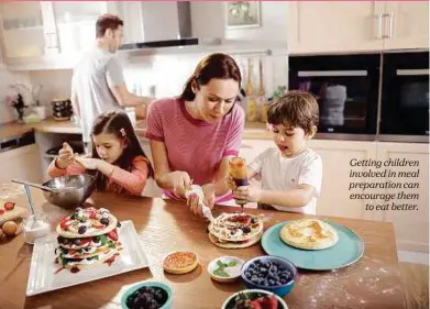  ??  ?? Getting children involved in meal preparatio­n can encourage them to eat better.