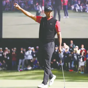 ?? CHUNG SUNG-JUN/GETTY IMAGES ?? Tiger Woods raises his arm in victory Monday morning after winning the ZOZO Championsh­ip in Japan. It marks Woods’ 82nd career PGA victory, tying him for most all time with Sam Snead.