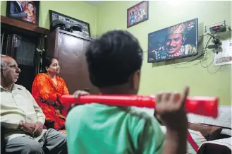  ?? THE ASSOCIATED PRESS ?? An Indian family watches the Hindu religious drama series Ramayan at their home in Jammu, India. The country’s public broadcaste­r last month revived the wildly popular series from the 1980s for a captive audience under lockdown.