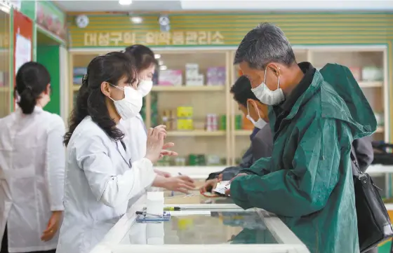  ?? AP-Yonhap ?? ◄ Employees of the Medicament Management Office of the Daesong District in Pyongyang provide medicine to residents as the state increases measures to stop the spread of illness in Pyongyang, North Korea, on May 16.