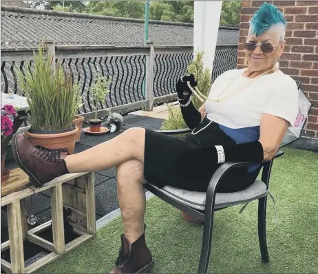  ??  ?? AMAZING Jill looking the part with her green mohican, a glass of champagne and some Dr Martens boots