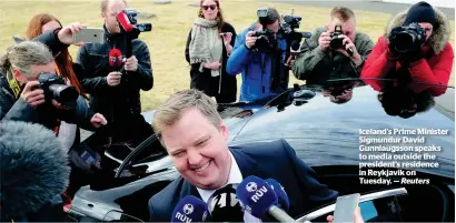  ?? — Reuters ?? Iceland’s Prime Minister Sigmundur David Gunnlaugss­on speaks to media outside the president’s residence in Reykjavik on Tuesday.