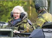  ?? Philipp Schulze dpa ?? CHRISTINE LAMBRECHT takes a tank ride in February at a training center in Muenster, Germany.