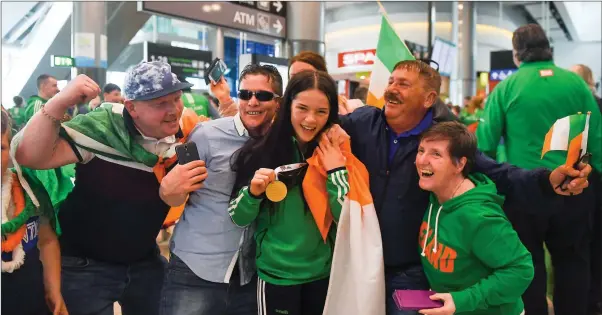  ??  ?? Gold medallist Daina Moorehouse and her family at the Team Ireland homecoming at Dublin Airport.