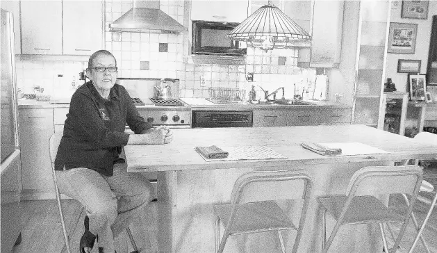  ?? GREG SOUTHAM/ EDMONTON JOURNAL FILES ?? Culinary tour leader Gail Hall in her kitchen in the Cobogo Lofts on 104th Street, where she hosts cooking classes after leading a stroll through the City Market.