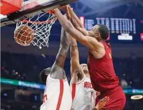  ?? Ron Schwane/Associated Press ?? Cavaliers forward Evan Mobley, right, throws down a dunk over the Rockets’ Usman Garuba, left, and Jabari Smith Jr. for two of his 19 points Sunday.