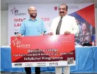  ??  ?? Informatic­s Group Founder and Chairman Dr. Gamini Wickramasi­nghe handing over InfoSchol scholarshi­ps to Alethea Internatio­nal School