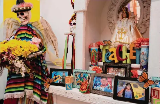  ?? ?? Top: An ofrenda created by Luis Gavito honors the 19 students and two teachers killed in the shooting at Robb Elementary in Uvalde.