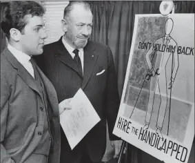  ?? AP FILE PHOTO ?? In this March 22, 1963, file photo, Nobel prize-winning author John Steinbeck, right, admires a prize-winning poster by his son, Thomas Steinbeck in Hartford, Conn. A three-judge panel of the Ninth U.S. Circuit Court of Appeals will be in Alaska’s largest city on Tuesday, Aug. 6, 2019, to hear arguments in an appeal by the estate of Steinbeck’s late son, Thomas Steinbeck, over a 2017 ruling in California. In that case, a federal jury awarded the author’s stepdaught­er Waverly Scott Kaffaga, more than $13 million in a lawsuit claiming Steinbeck’s son and daughter-in-law impeded film adaptation­s of the iconic works.