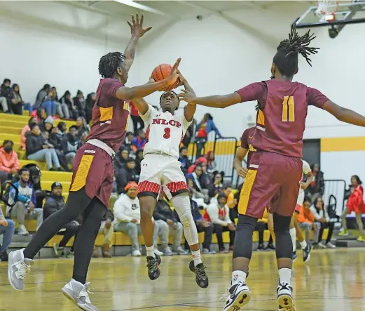  ?? KIRSTEN STICKNEY/SUN-TIMES ?? North Lawndale senior point guard Jemarje Windfield, who had 17 points, puts up a three-pointer against Marshall on Wednesday.