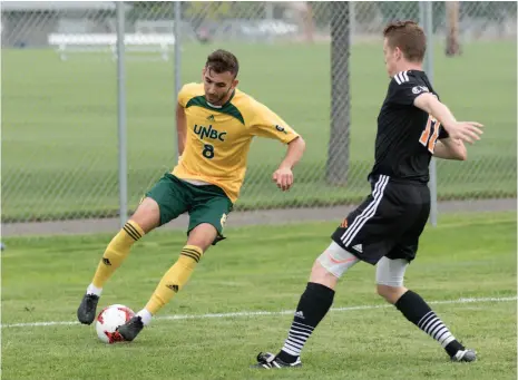  ?? CITIZEN FILE PHOTO ?? Francesco Bartolillo of the UNBC Timberwolv­es uses some slick footwork to keep the ball away from Thompson Rivers University WolfPack defender Adam Swanson during a Canada West men’s soccer game earlier this season at the North Cariboo Senior Soccer...