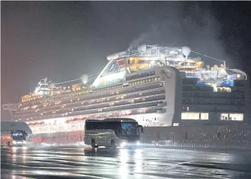  ?? BLOOMBERG ?? Buses with passengers believed to be US citizens drive away from the ‘Diamond Princess’ docked in Yokohama, Japan, on Monday.