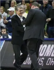  ?? JESSICA HILL — THE ASSOCIATED PRESS ?? Connecticu­t head coach Geno Auriemma shakes hands with Saint Francis (Pa.) head coach Joe Haigh, right, at the end of Saturday’s first-round game in the NCAA women’s college basketball tournament in in Storrs, Conn.