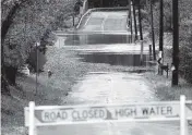  ?? MATT ROURKE AP ?? A barricade blocks access to a road flooded by recent rain in Branchburg, N.J., Tuesday.