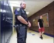  ?? Hearst Connecticu­t Media file photo ?? Brookfield Police Officer Devin Quintard protects the campus of Brookfield High School in 2013.