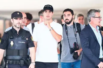  ?? — AFP photo ?? Alcaraz (centre) walks out upon his arrival at the airport of Valencia in Manises on the eve of the start of Spain’s Davis Cup group stage matches in Valencia.