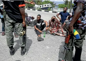  ?? AP ?? Police search bus passengers in Lagos yesterday morning. Nigeria’s streets are relatively calm again after days of protests over police abuses and corruption.