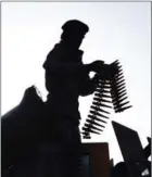  ?? WAKIL KOHSAR/AFP ?? An Afghan security guard adjusts his weapon as he stands on an armoured humvee vehicle in Kabul on June 16.