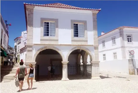  ?? PHOTOS: RUSSELL CONTRERaS/THE ASSOCIATED PRESS ?? Tourists pass by Mercado de Escravos, or the Slave Market, which now serves as a museum in Lagos, Portugal. The building sits on the site where the first captured West Africans were sold into slavery in Europe.