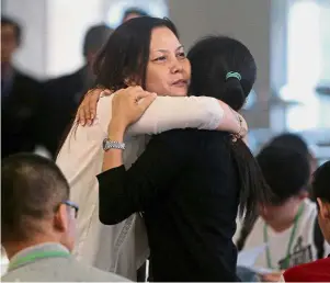  ?? — Reuters ?? Strength in difficult times: Family members arriving for the MH370 briefing in Putrajaya.