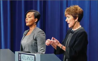  ?? HYOSUB SHIN / HSHIN@AJC.COM ?? Atlanta may oral candidate Mary Nor wood( right) speaks as Keisha Lance Bottoms listen s during their first runoff debate at Public Broadcast ion Atlanta on Thursday. The nonpartisa­n mayor al and City Council president runoffelec­tions will be held Dec. 5.