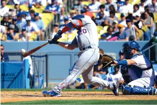  ?? MARK J. TERRILL/ASSOCIATED PRESS ?? New York Mets’ Pete Alonso hits an RBI double during the eighth inning against the Los Angeles Dodgers on Sunday in Los Angeles.