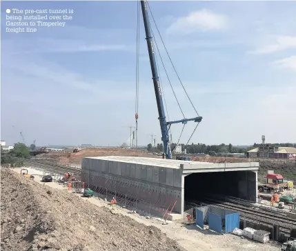  ??  ?? The pre-cast tunnel is being installed over the Garston to Timperley freight line