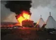  ?? STEPHEN YANG/GETTY IMAGES NORTH AMERICA/AFP ?? Campers set structures on fire in preparatio­n of the Army Corp’s deadline to leave the Oceti Sakowin protest camp on Wednesday.