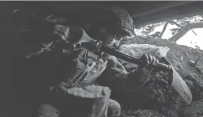  ?? GETTY IMAGES ?? A Ukrainian infantryma­n continues to build the fortificat­ions of his dugout on Nov. 3 in Bakhmut District, Ukraine, the frontline of the Russian-Ukrainian war.