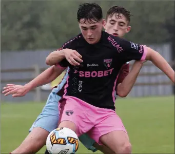  ??  ?? Jack Healy uses his strength to hold off a Cobh Ramblers opponent during Sunday’s clash.