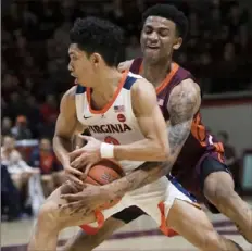  ?? The Associated Press ?? Virginia Tech’s Nickel Alexander-Walker tries to knock the ball away from Virginia’s Kihei Clark Monday in Blacksburg, Va.