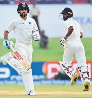  ?? AFP ?? Indian cricket team captain Virat Kohli (left) and Abhinav Mukund run between the wickets during the third day of the first Test against Sri Lanka at Galle Internatio­nal Stadium yesterday.