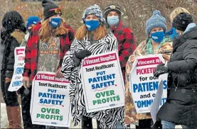  ?? CHRIS CHRISTO/ BOSTON HERALD ?? Nurses at Saint Vincent Hospital in Worcester turned down a contract proposal that increased some staffing levels and pay, saying the offer wasn’t enough to avoid a strike planned for Monday. Here, they picket on Feb. 18.